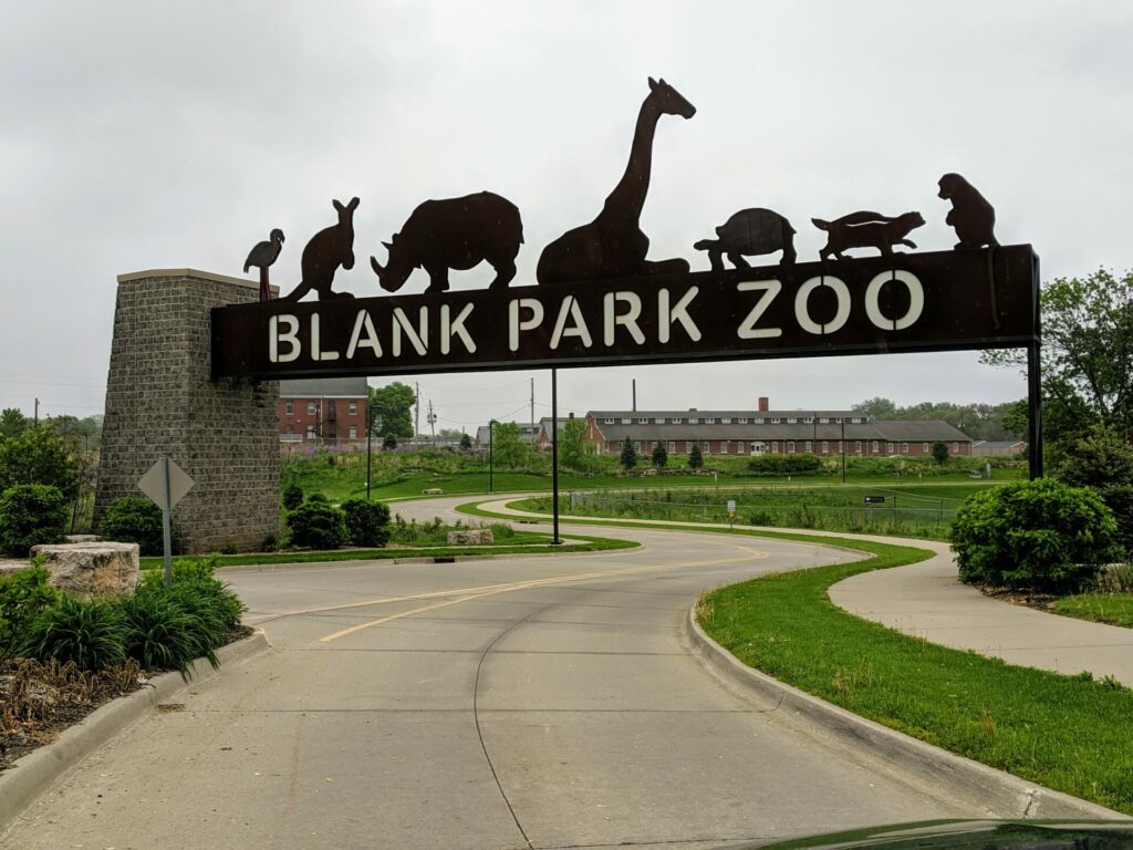 Welcoming entrance to Blank Park Zoo, featuring a playful sign, inviting visitors of all ages to explore the diverse wildlife and exciting exhibits within.
