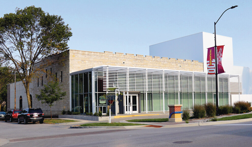 Exterior view of the Des Moines Playhouse, showcasing its welcoming facade and inviting entrance, signaling a world of theatrical entertainment within.