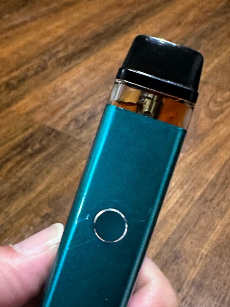 Vaporesso XROS2 device with pod attached and e-liquid visible through the pod