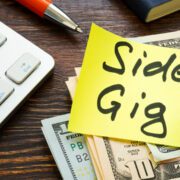 Banner image for the post, "25 Side Gigs You Can Start In 2023 Without Breaking the Bank" featuring a Post-It Note that reads "Side Gig".
